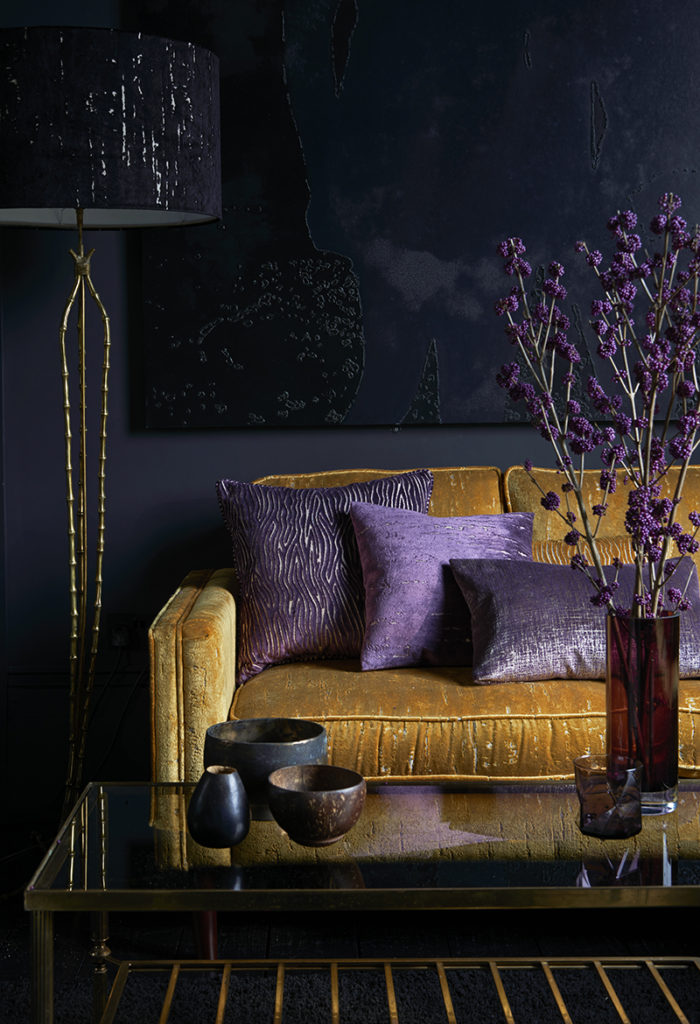 photo of dark purple themed room with orange sofa in it 
