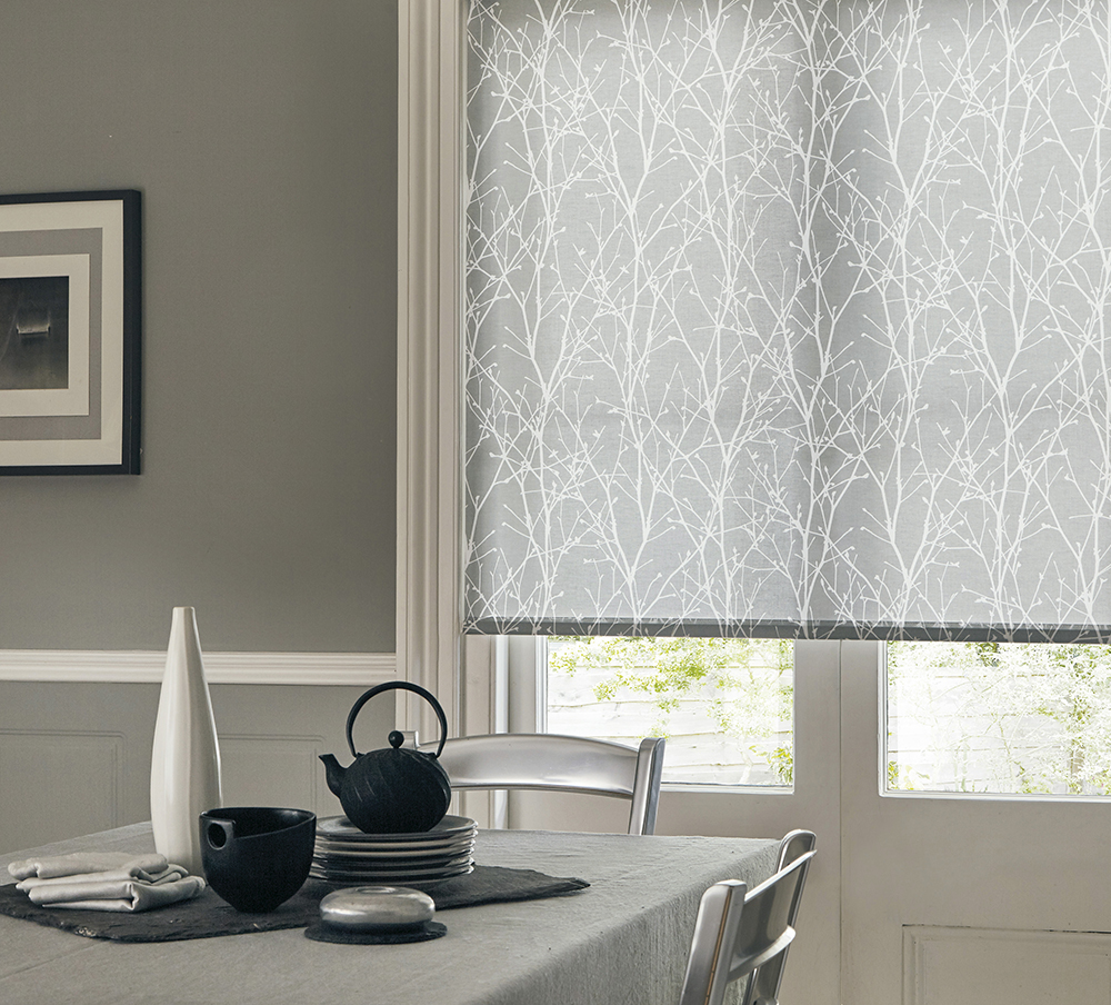 Modern grey dining room with patterned roller blind