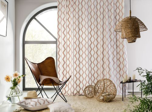 Retro living room with wicker accessories and geometric curtains