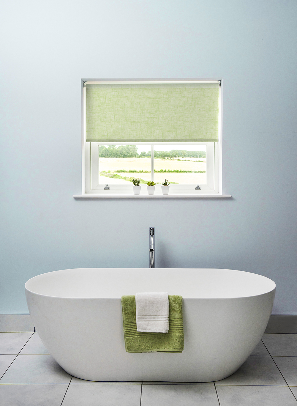 image of stand alone bath in front of a sea breeze painted wall 