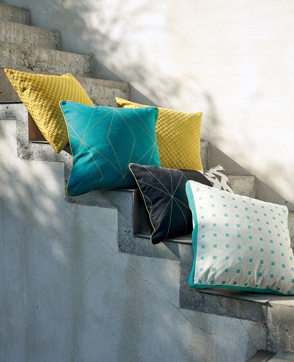photo of outdoors steps with teal and yellow cushions resting on top 