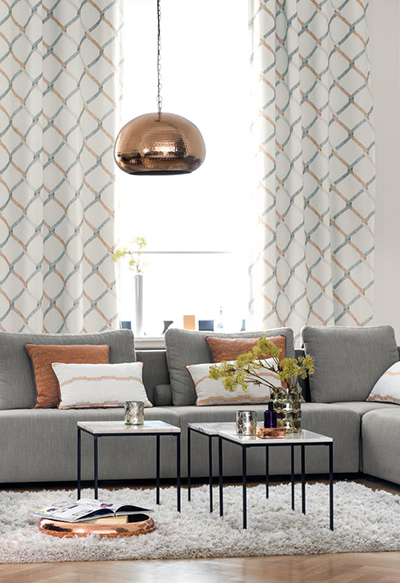 Living room with grey sofa and rose gold accessories