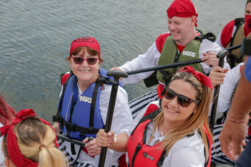 photo of people wearing life jackets next to a river