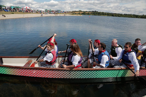 a photo of group of people in a rowing boat