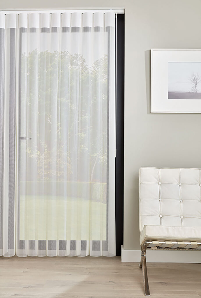 image to show white illusion blinds from the Uk next to cream chair and light grey wall
