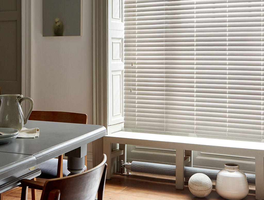 photo of grey wooden blinds in living room to show example of the most popular coloured blinds 