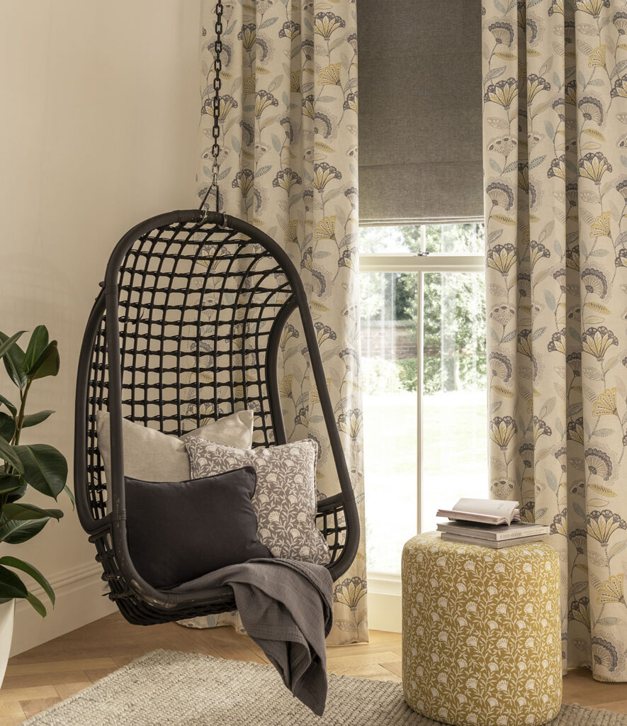 modern Spanish style swinging chair next to window with curtains in Iberian interior design  