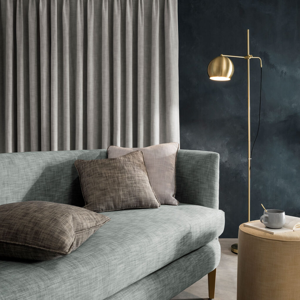 image of charcoal wall with sage green sofa to show options for colours to go with grey