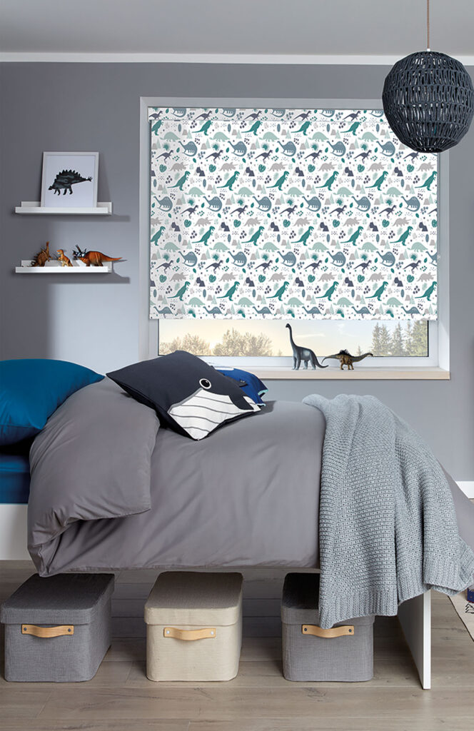 photo of older kids bedroom layout with grey bed and dinosaur roller blinds 