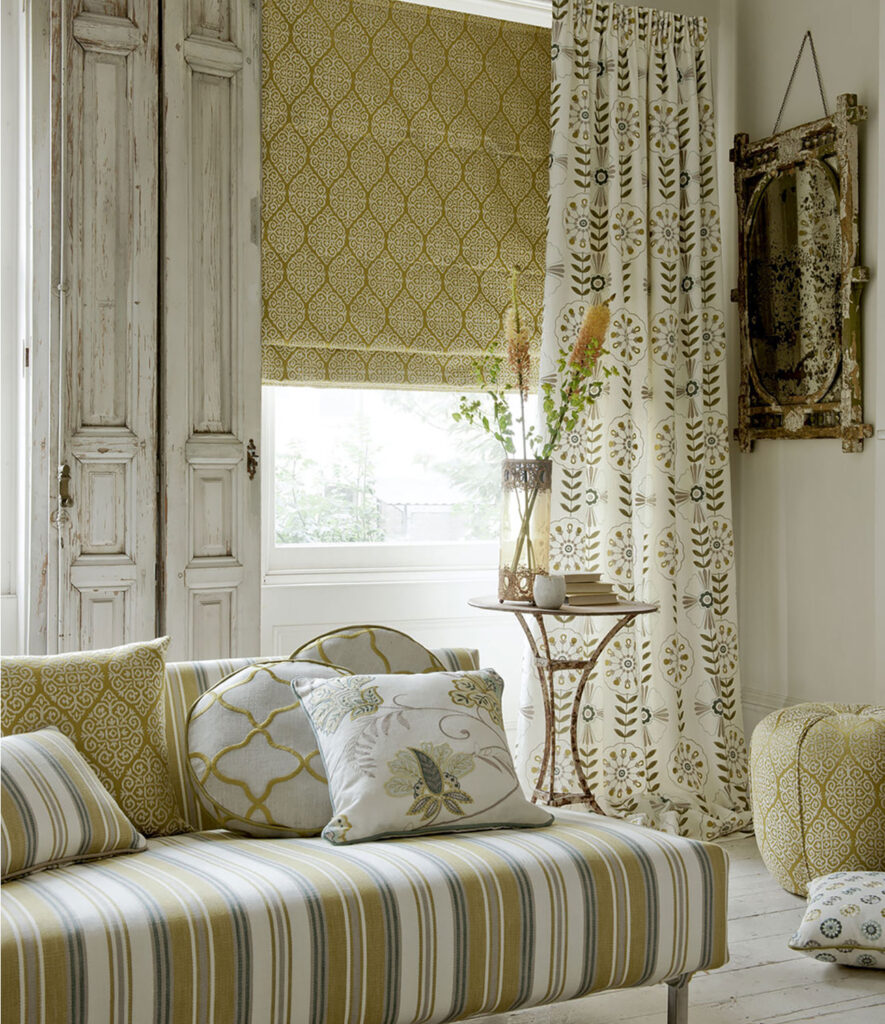 ivory interior with gold striped sofa and white cushion with beige roller blind 