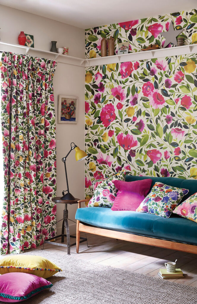 photo of floral curtains and feature wall with green sofa a pink cushion in a maximalist design 