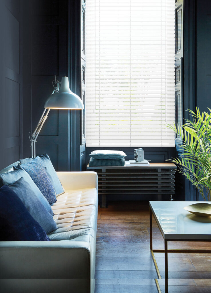 light grey made to measure wooden blinds in pastel blue room with house plant and table
