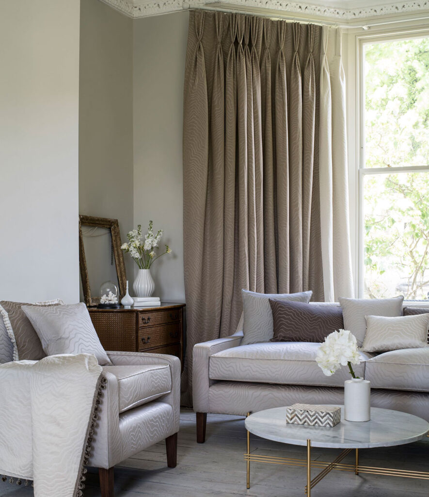 photo of brown curtains made for bay windows in living room setting with 2 grey sofas