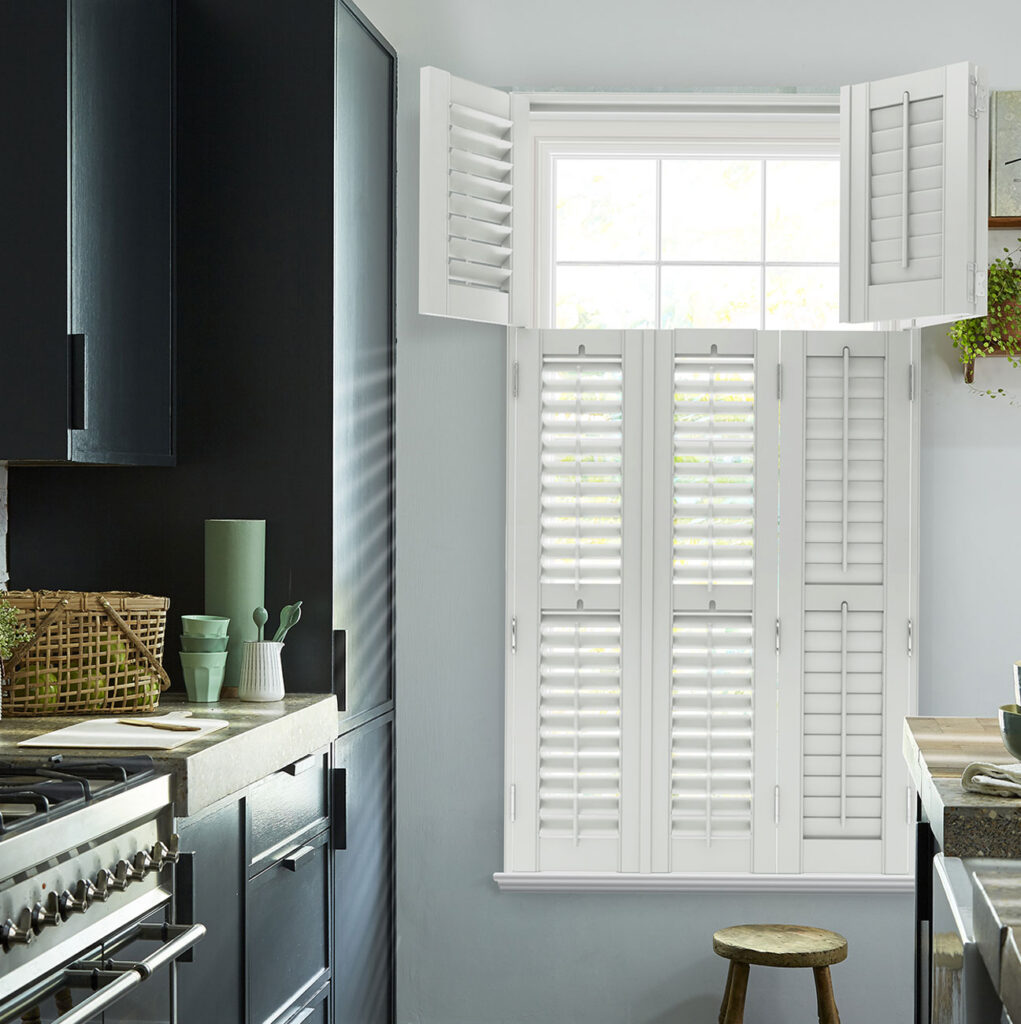 kitchen with white british seaside inspired shutter and wooden stool