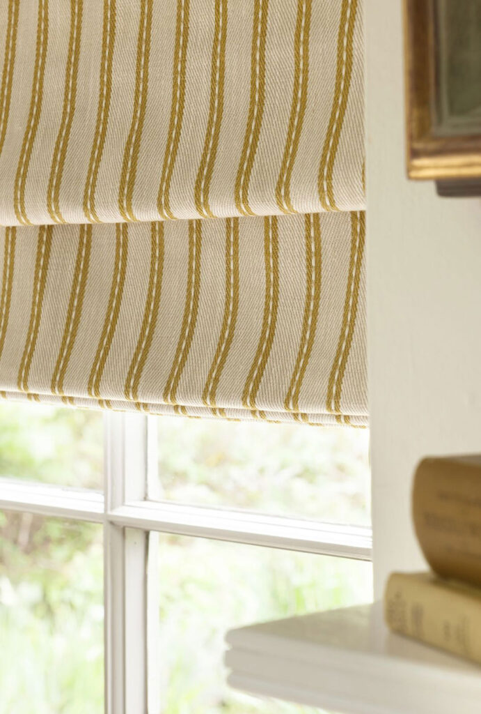 textured curtain with yellow coloured pinstripe to show the colour of yellow meaning for interior design 