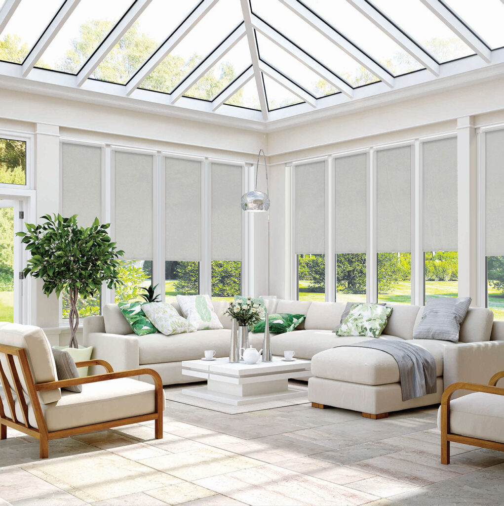 image of conservatory with sofa and chairs and open windows with Perfect Fit® blinds for conservatories 