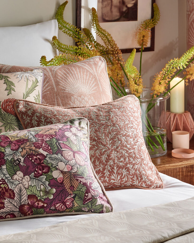 floral cushions on bed to show an example of cottagecore interior design 