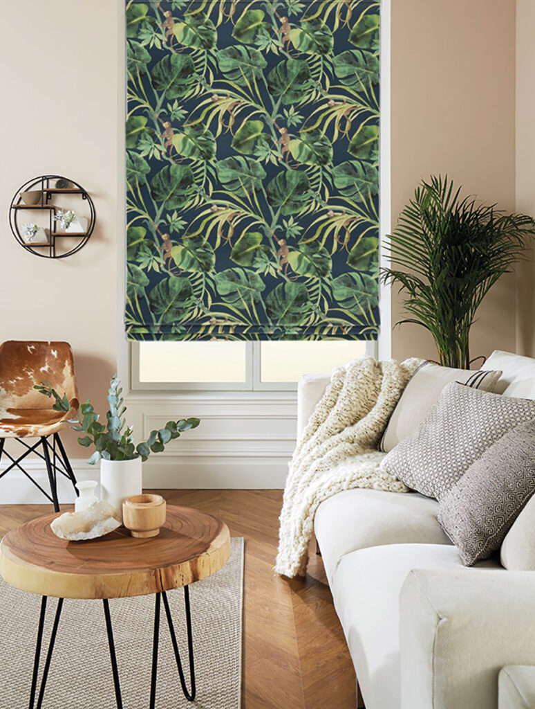 image of jungalow styled living room with potted plants and floral roller blind
