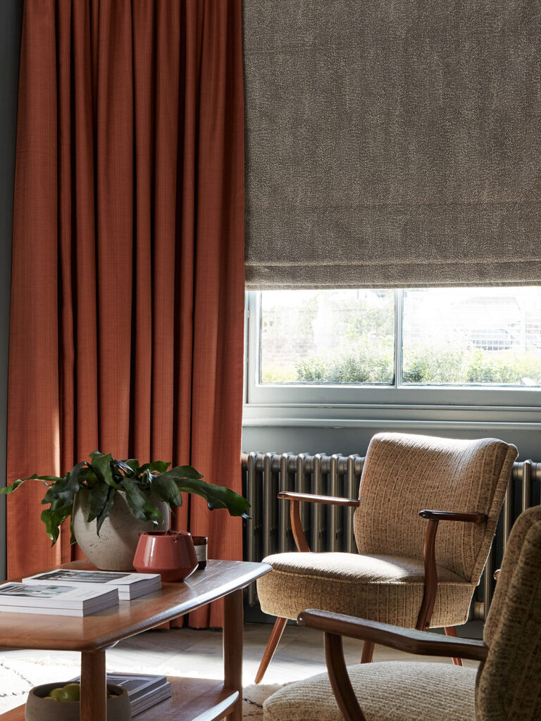photo of orange curtain with grey roman blind to give ideas for how to use curtains