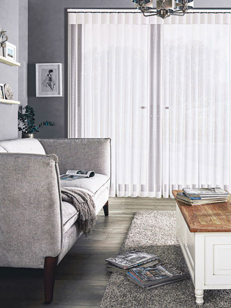image of grey themed living room with grey sofa next yo french doors with illusion blinds fitted
