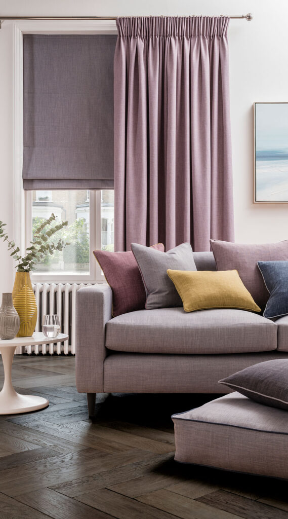 photo of living room with sofa next to window with the colour lilac curtains