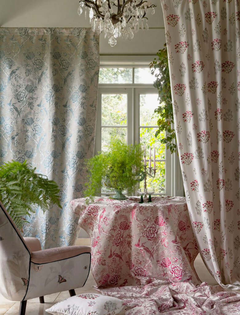 photo of dining room with table and chandelier next to window with curtains to show example of using floral pattern in design