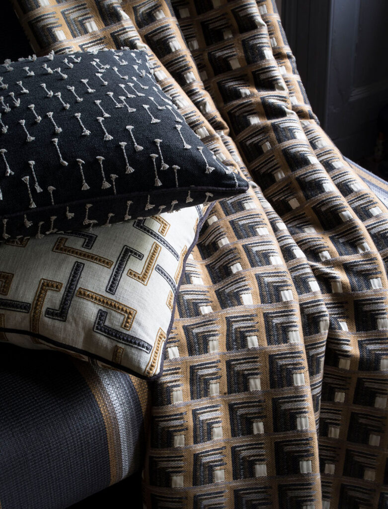 image of dark cushion and throw to show how you can use geometric pattern in design