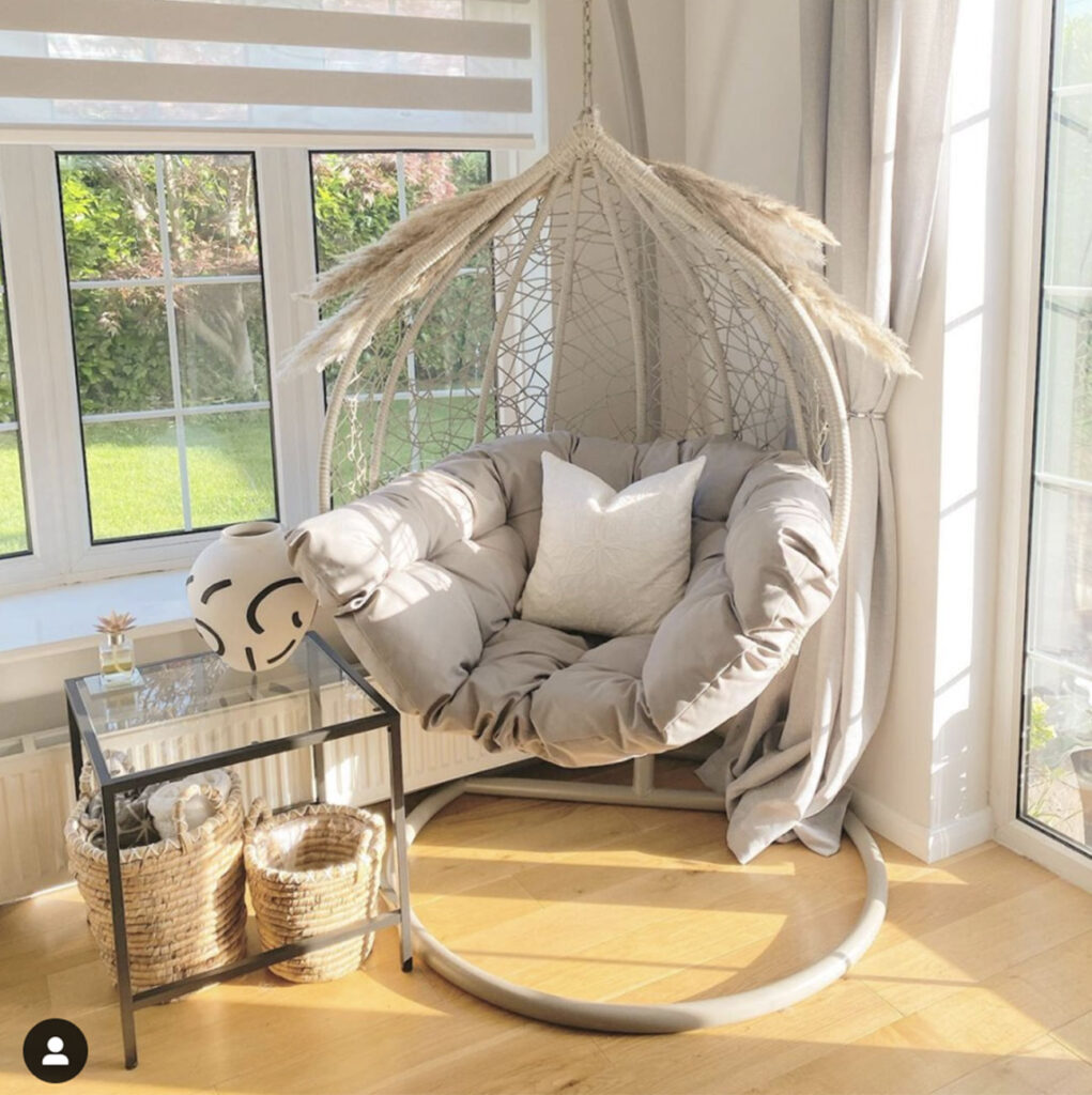 photo of cream colour themed room with hanging chair next to window with day and night blinds fitted 