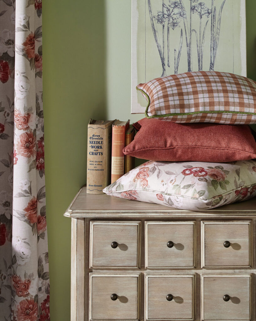 image of 3 cushions next to floral curtain to show example of village green interior decore