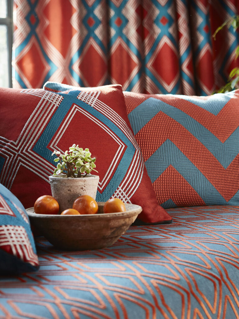 photo of two burnt orange coloured cushions on sofa