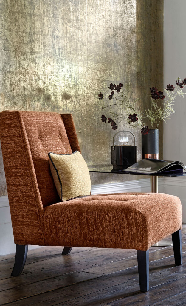 photo of golden wall with chair next to it to show which colours go well with orange