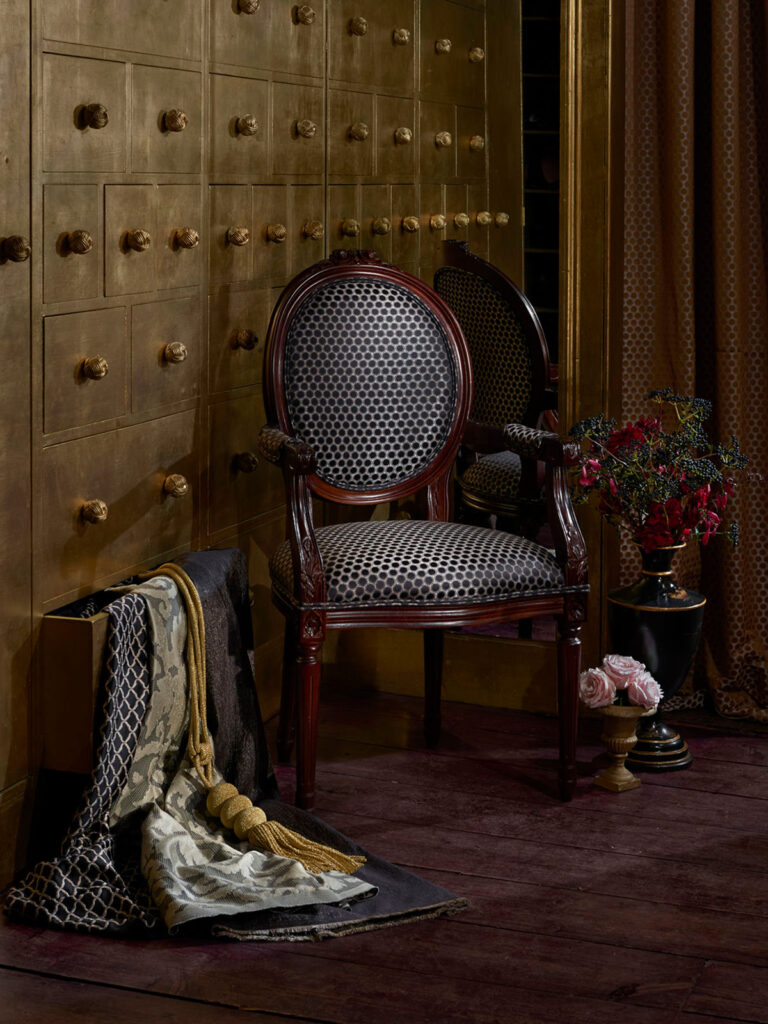 photo of black chair next to gold drawers