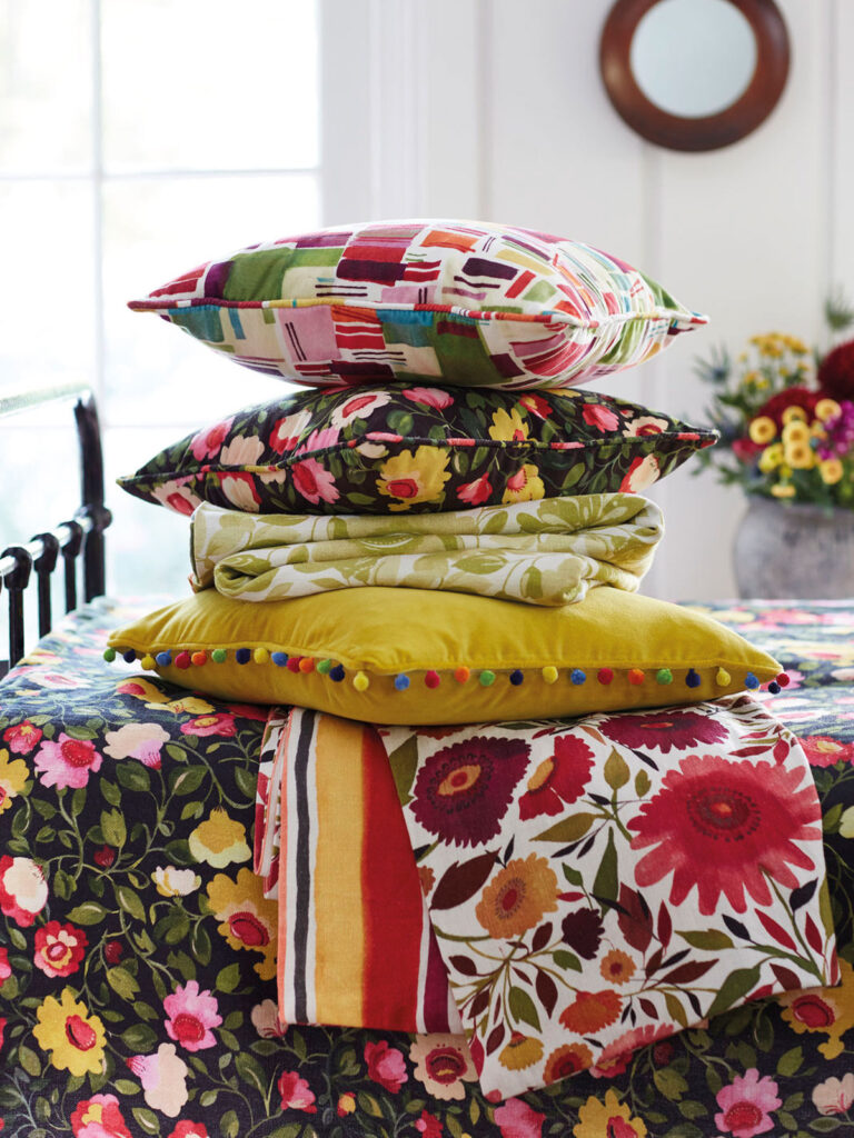 image of folk art inspired cushions place on table with floral print