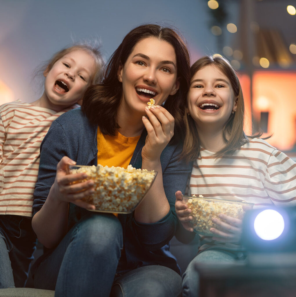 image of family enjoying a home cinema room with popcorn