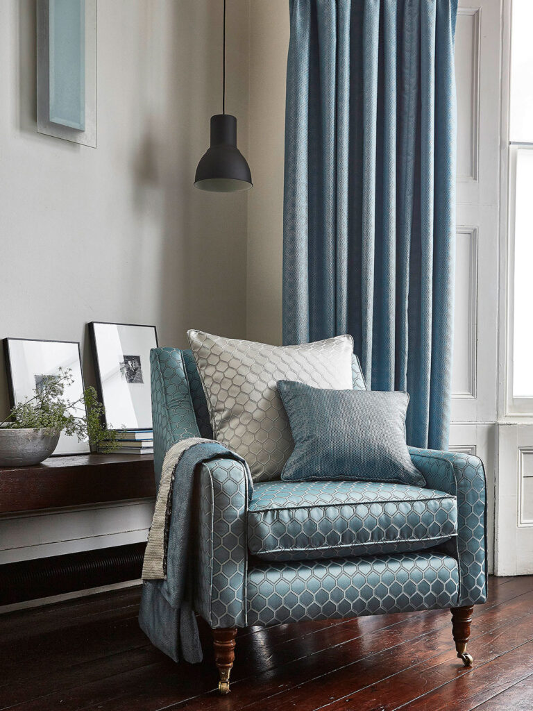 image of stone blue colour interior in living room with chair next to curtain