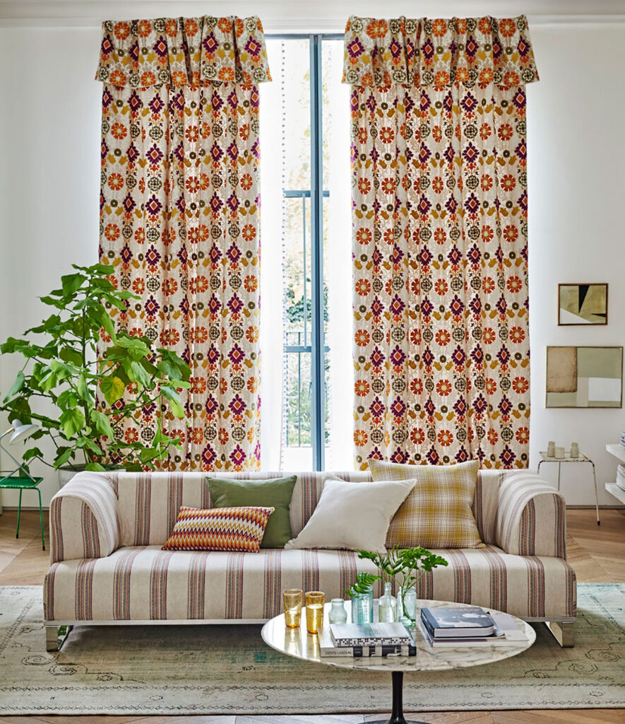 image of sofa with vertical stripes in front of window with striped curtains 