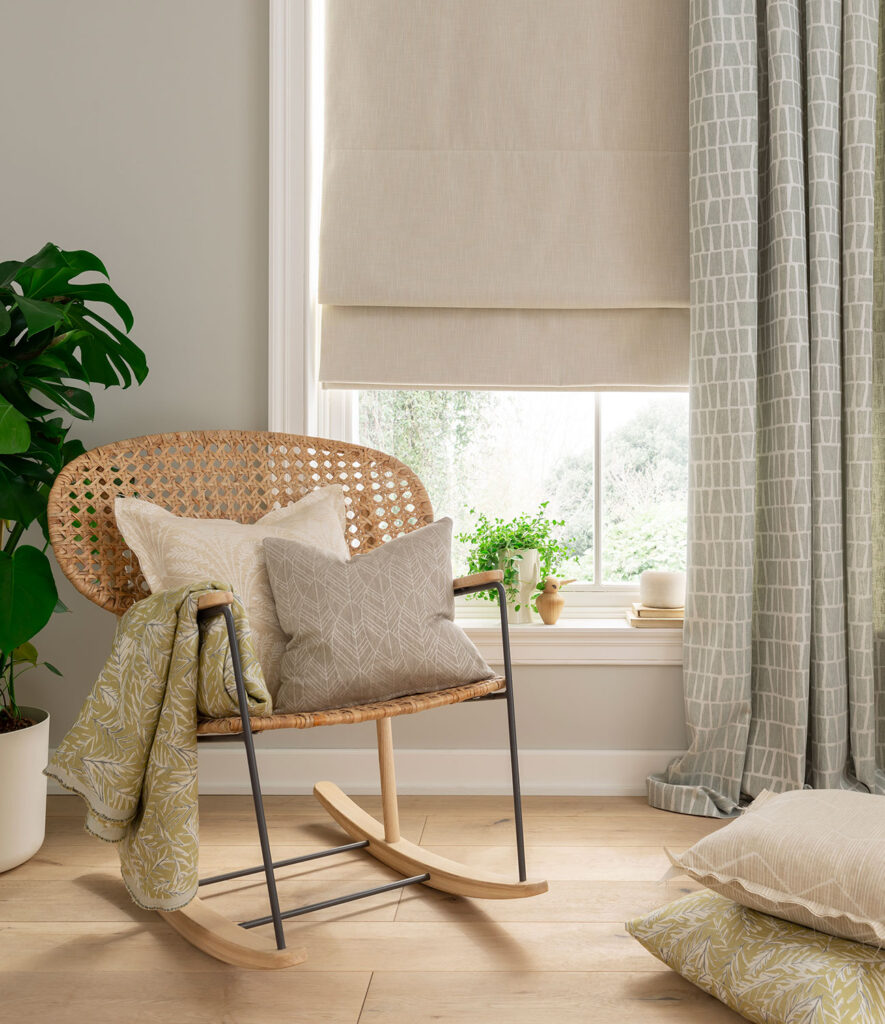 image of chair next to house plant with window net to it using linen roman blinds 