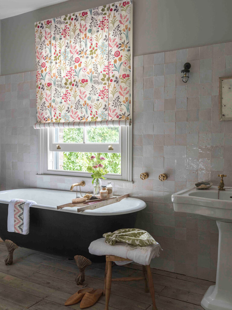 room set image of green bath tub next to window with style anglais roman blind 
