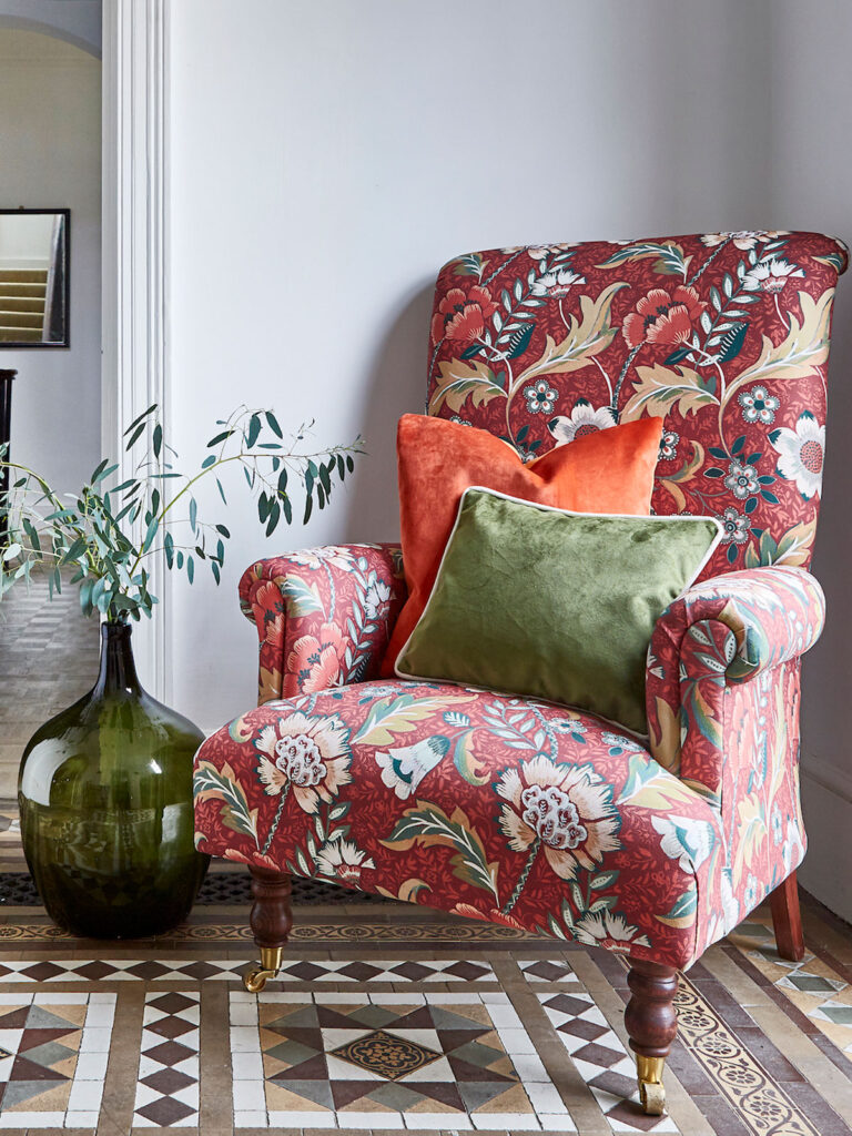 image of a red chair with style anglais print in white room with patterned floor