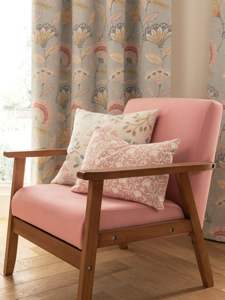 image of pink chair with pink and green cushions resting on it 
