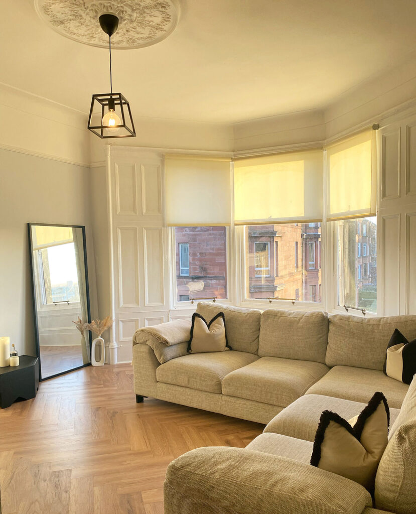 image of an instagram post that show a living room with blinds on large window 
