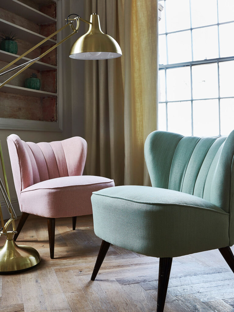 photo of two chairs with pink and green colour scheme in living room 