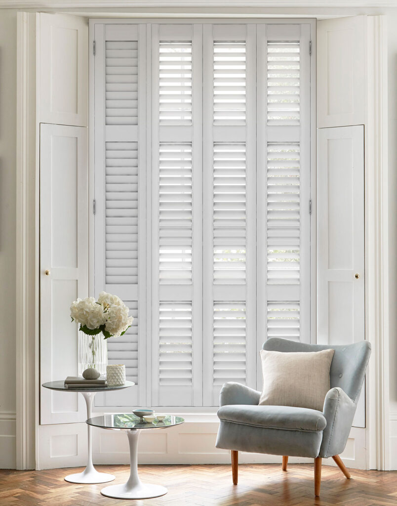 image of bay windows using full height white plantation shutters