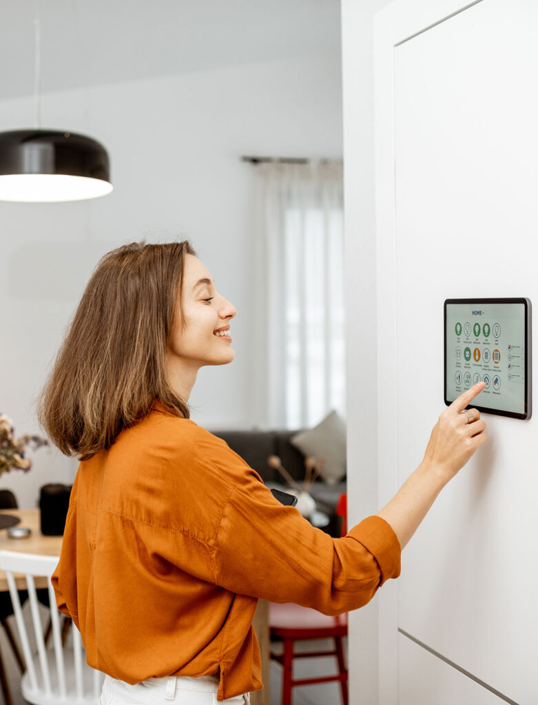 photo of woman with brown hair using smart controls at home 