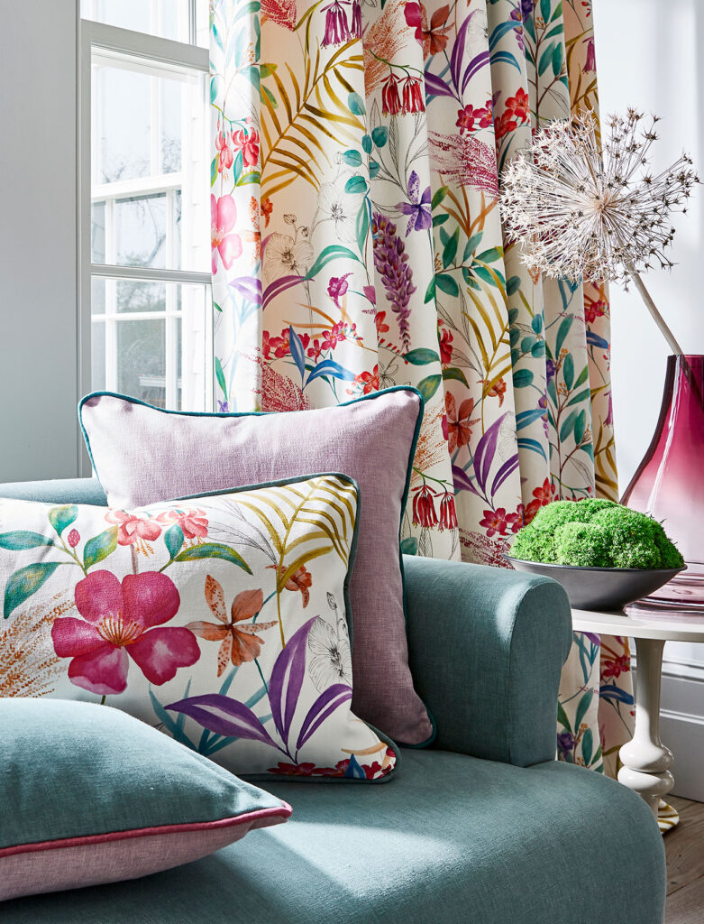 image of sofa next to window and floral curtain 
