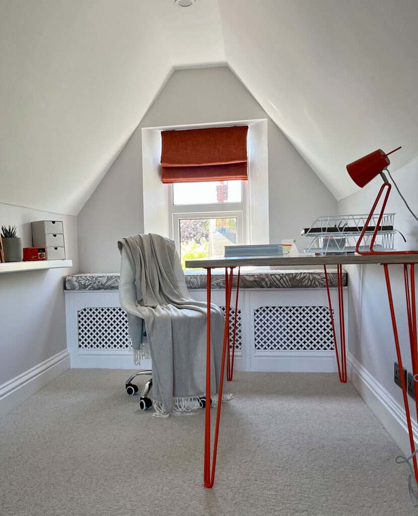 a photo showing example of customer using an orange roman blind 