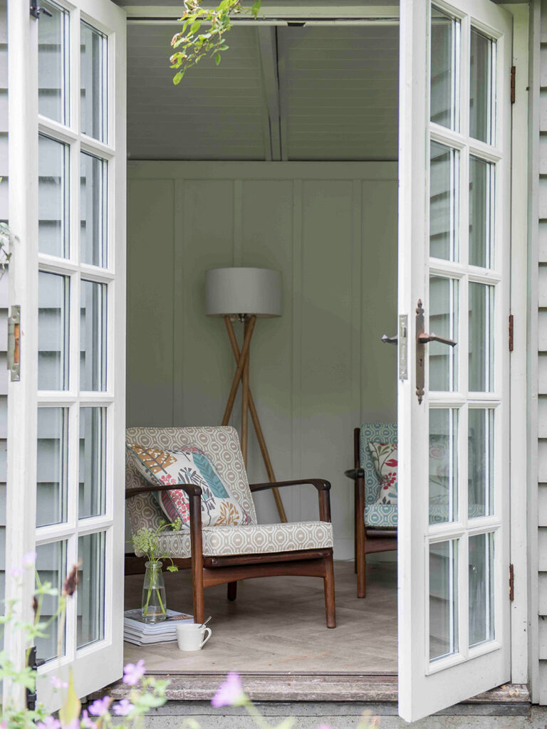 image of an open patio door showing pink chair