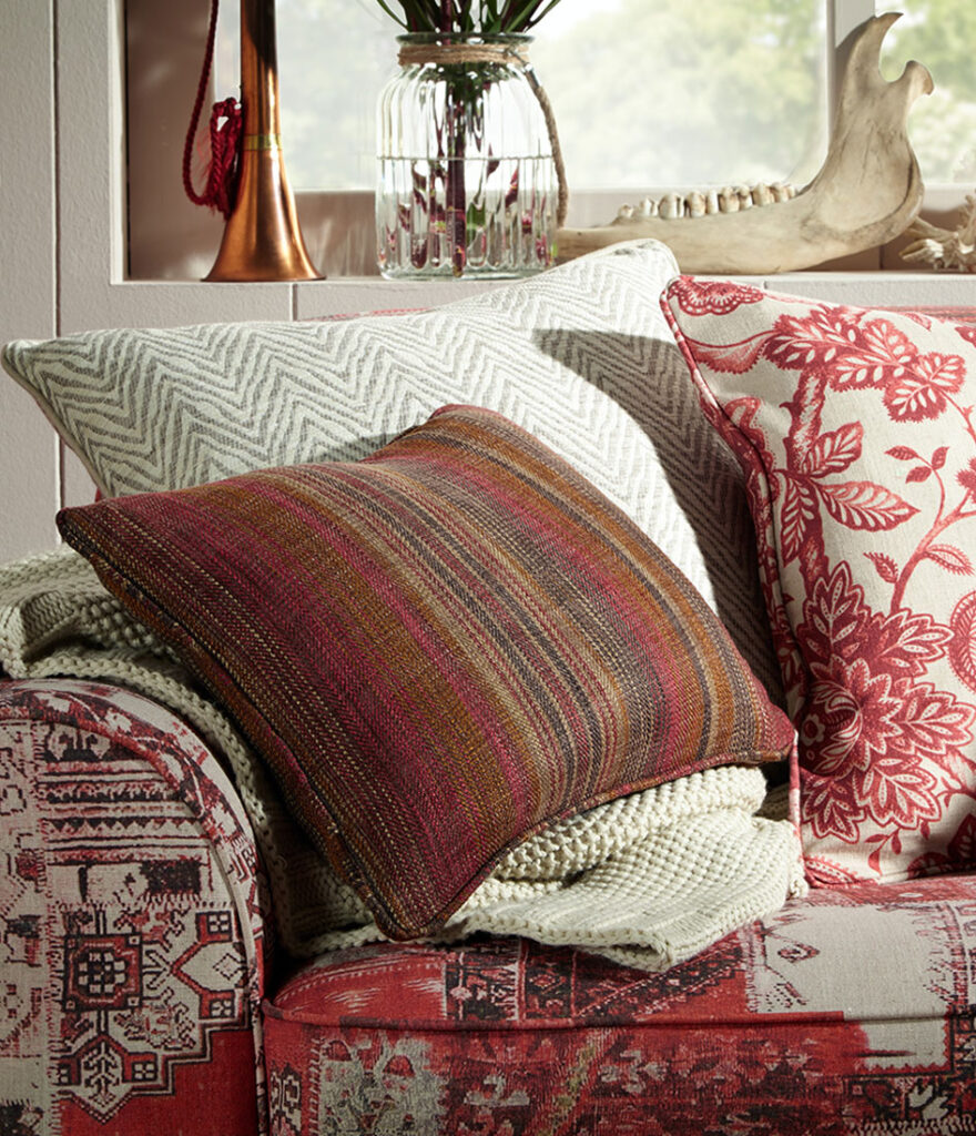 image of cushions on a sofa designed with warming colours 