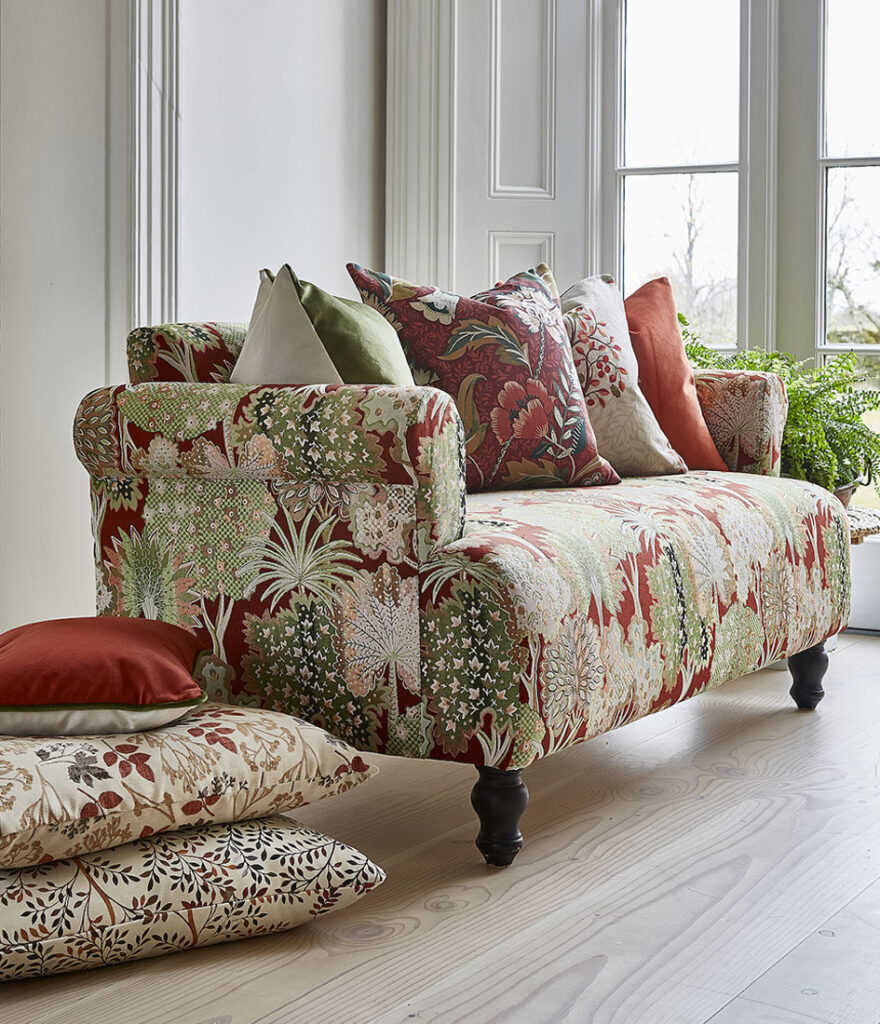 cushions with forest and berries prints on matching sofa.