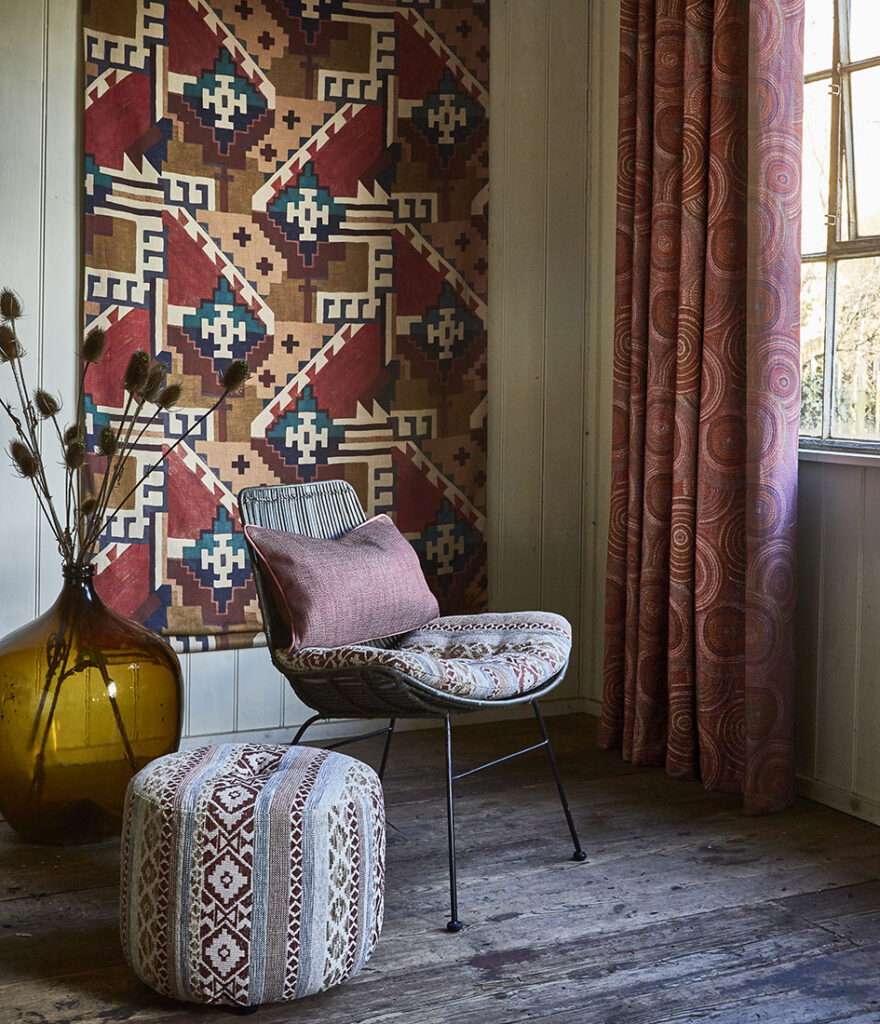 cosy red curtains in room with chair and vase in warm home decor.
